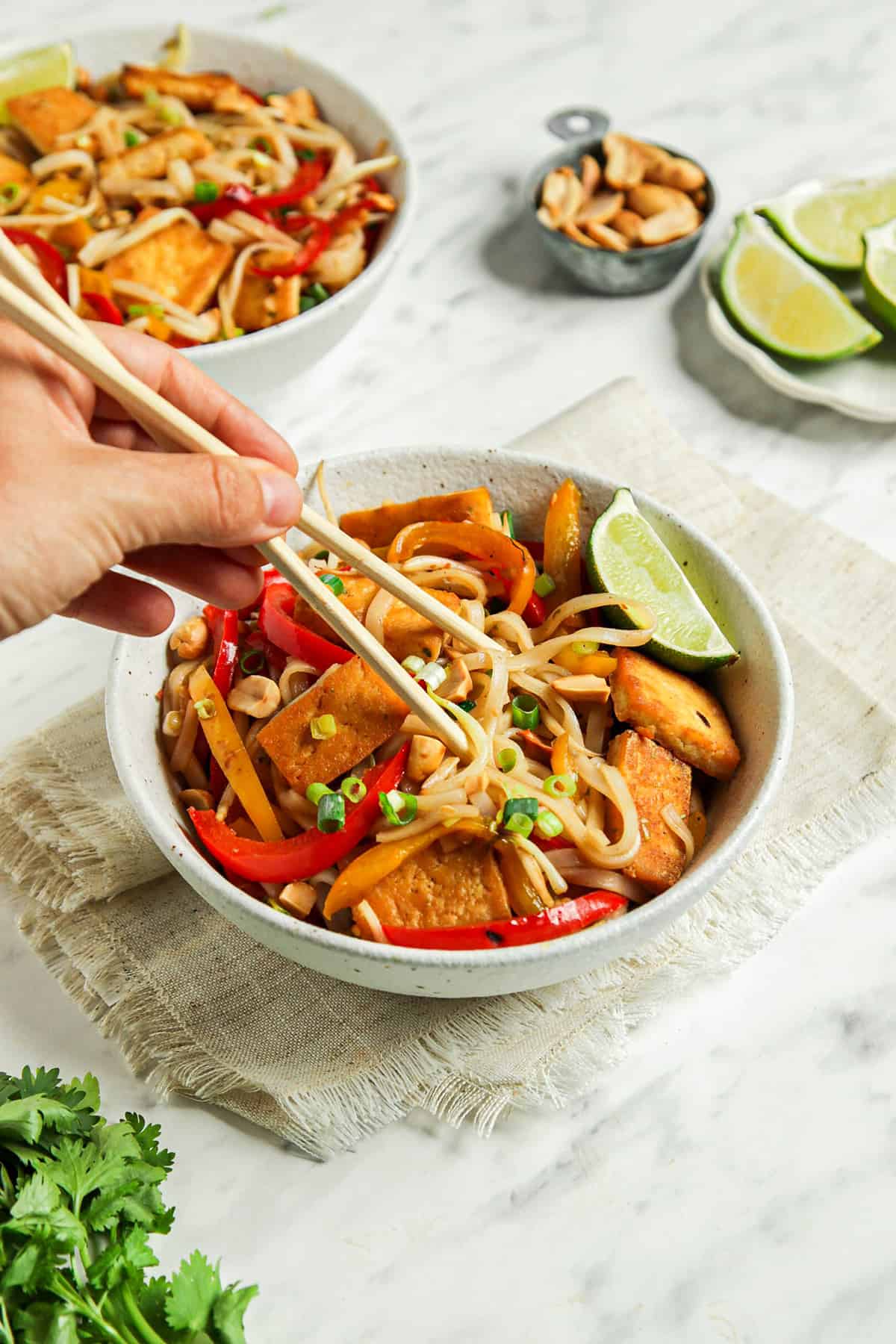 one bowl filled with vegan pad Thai noodles and tofu