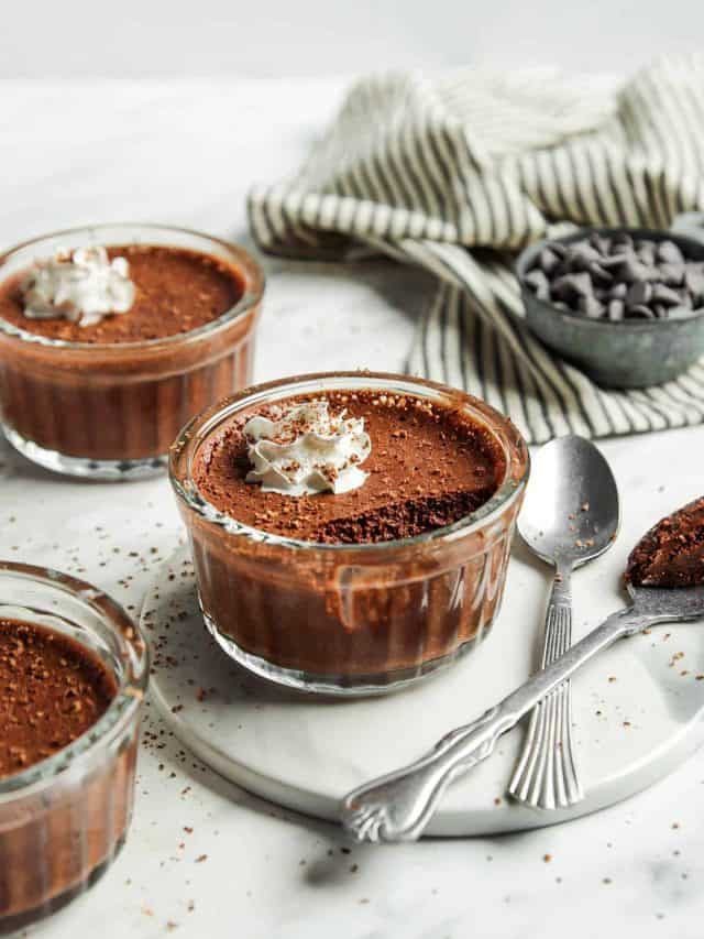 three glasses of vegan chocolate mousse with whipped cream