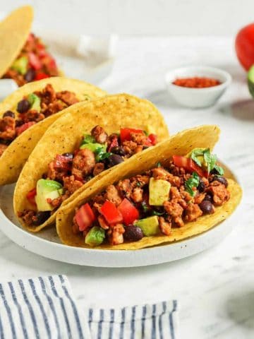 three tacos on plate