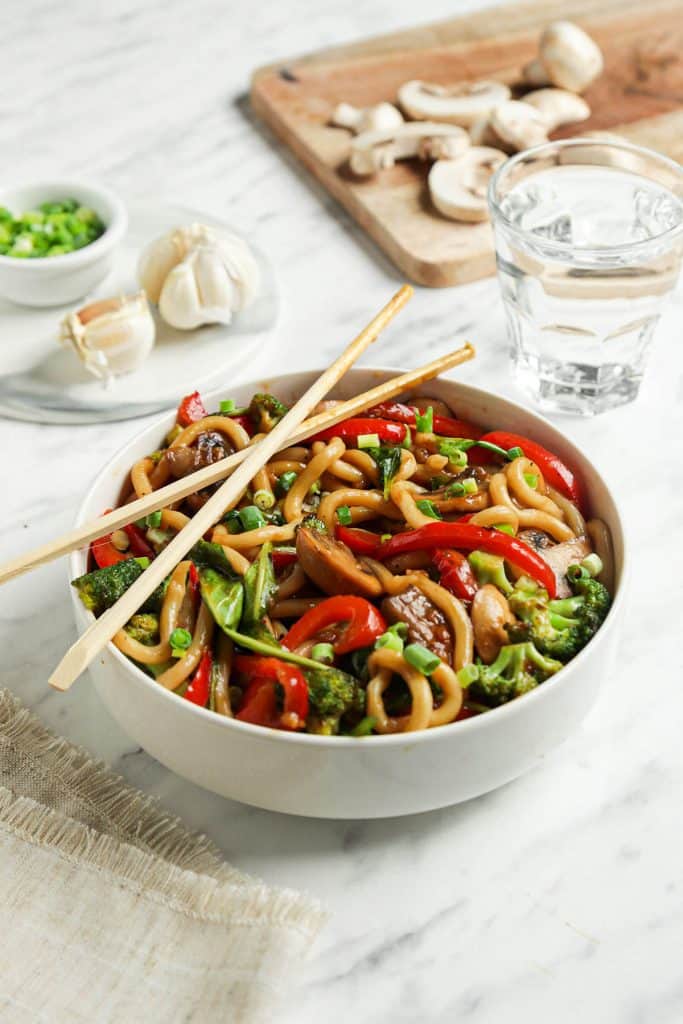 side angle of chop sticks on vegan noodle bowl