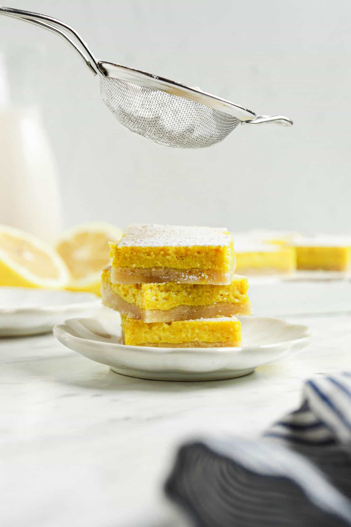 three vegan lemon bars on one white plate