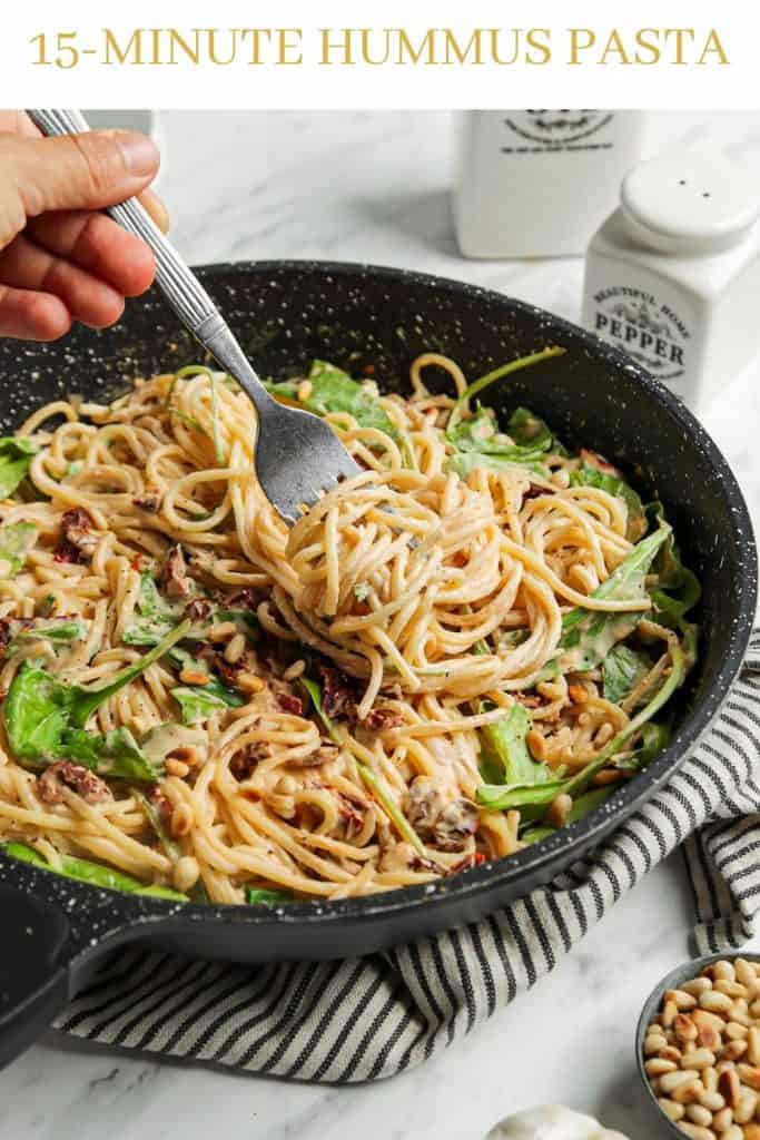 One pan filled with pasta and hummus sauce