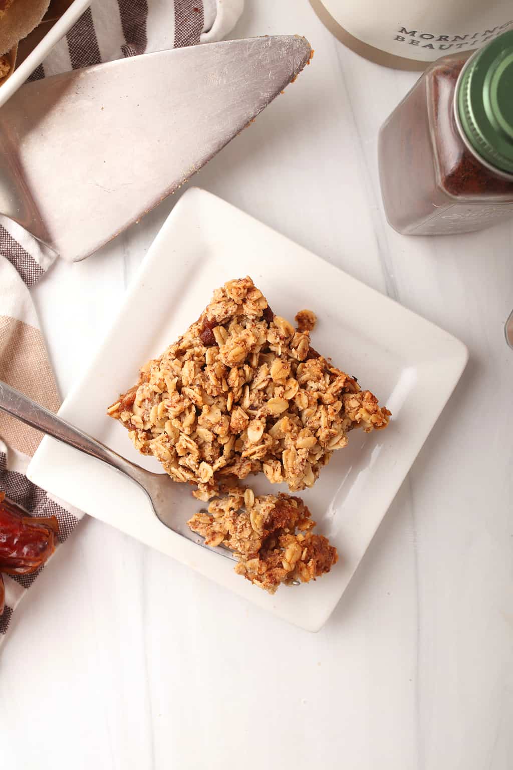 top view of gluten-free pumpkin oatmeal bars on white plate with fork