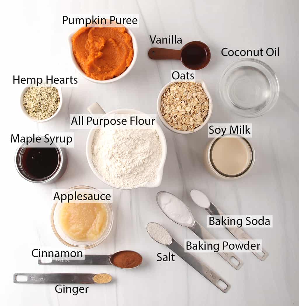 Ingredients for pumpkin muffins measured out and placed on a white countertop. 