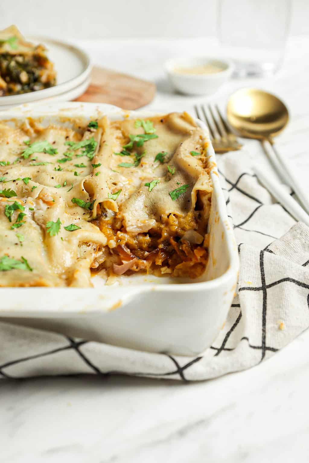 close image of butternut squash lasagna with fresh herbs 