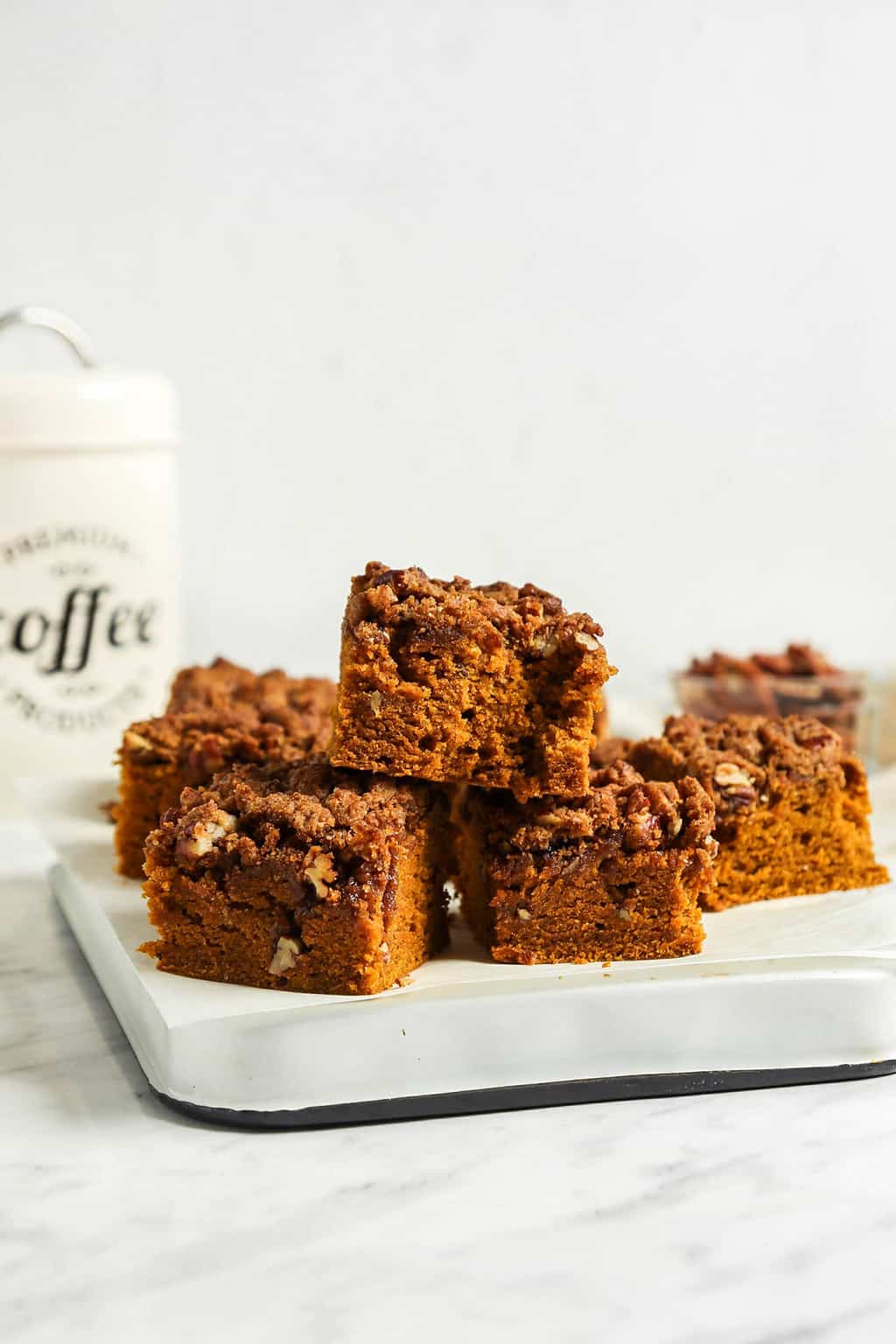 front view of stacked pumpkin coffee cake on white platter