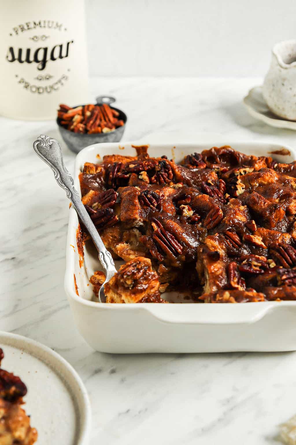 one baking pan filled with baked vegan bread pudding topped with sweetened pecans