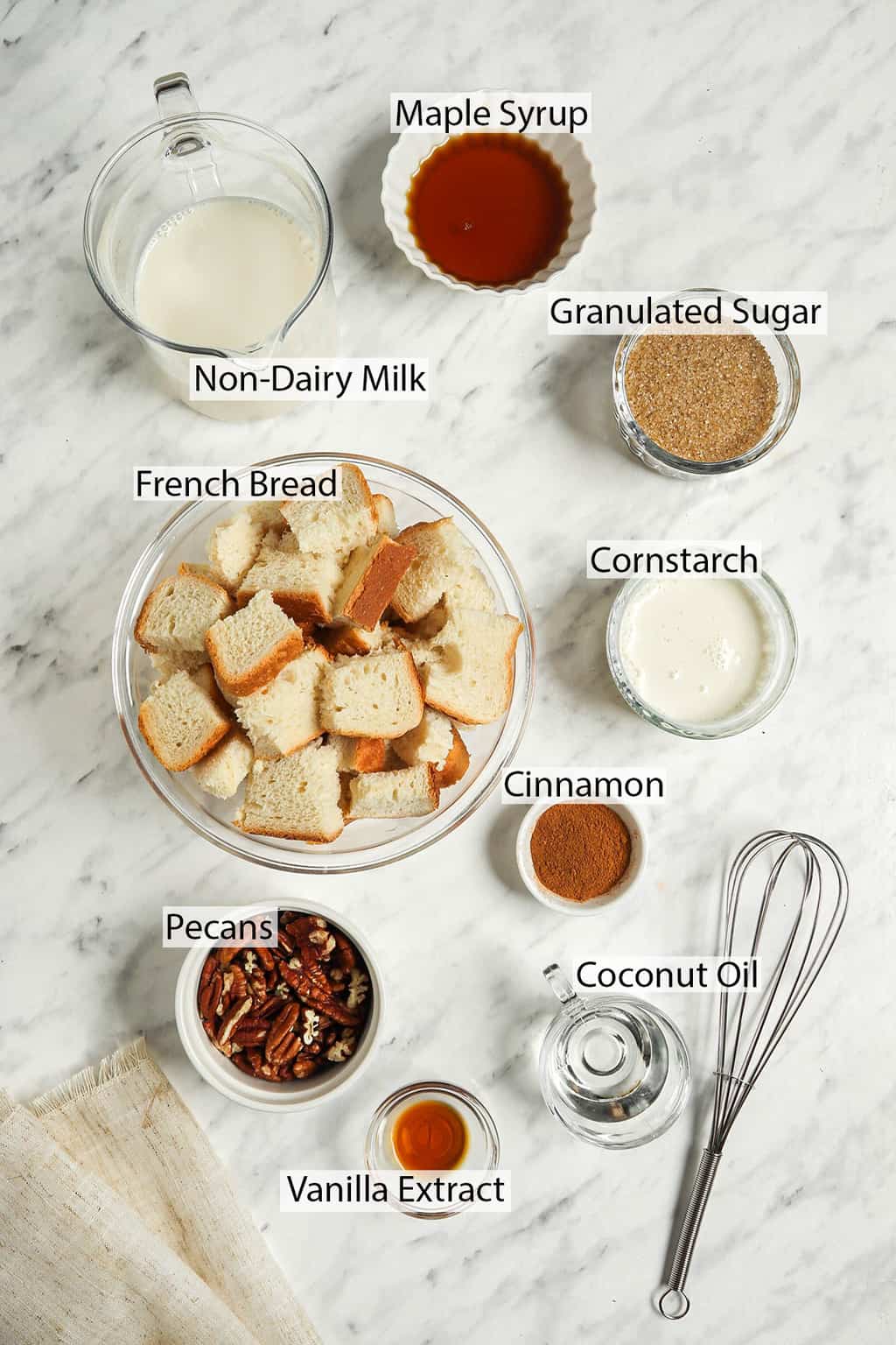 Ingredients for bread pudding measured out and placed on a marble countertop