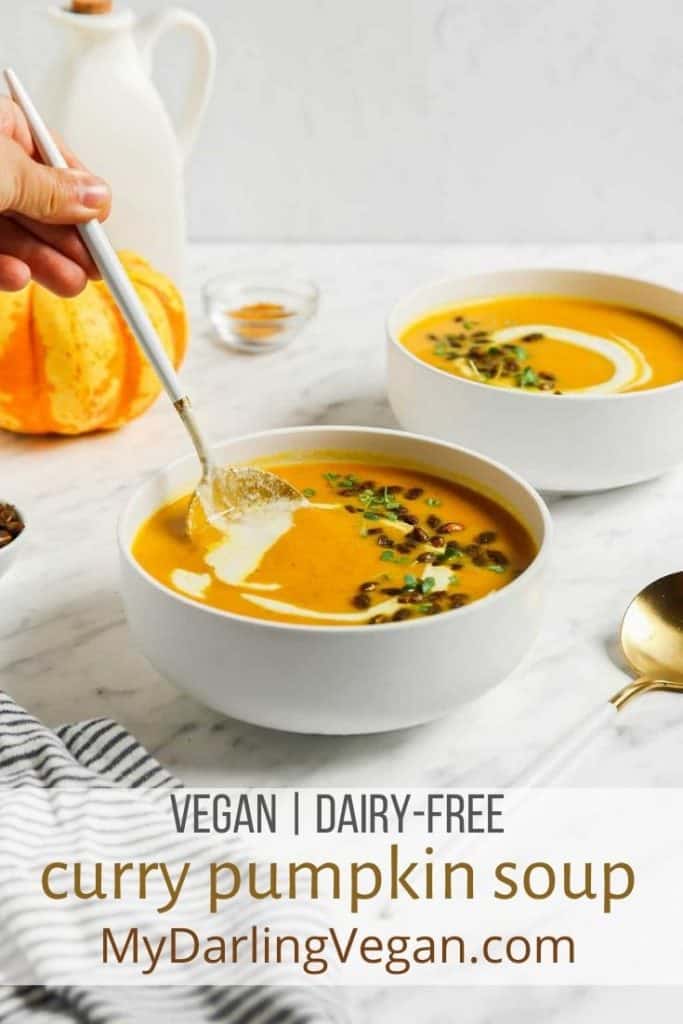 two bowls of pumpkin curry soup with toasted pumpkin seeds and Pinterest text