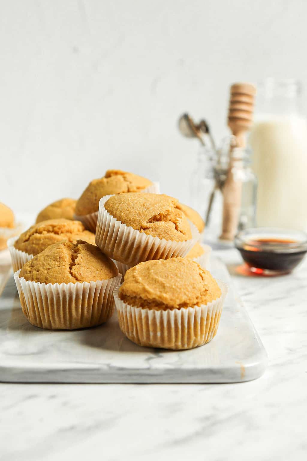 Stack of cornbread muffins on a marble serving platter.