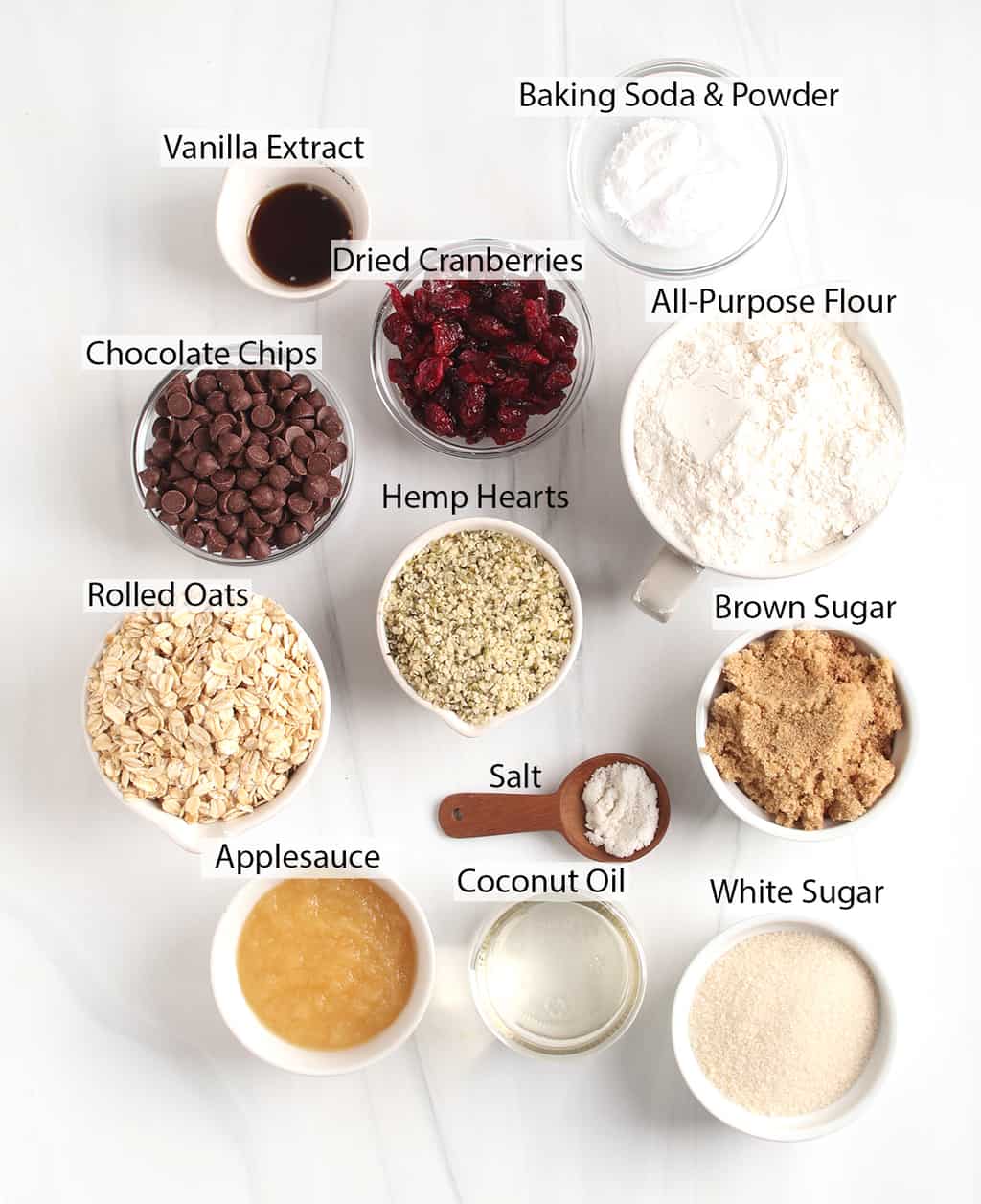 Ingredients for vegan cookies measured out and placed on a marble countertop. 