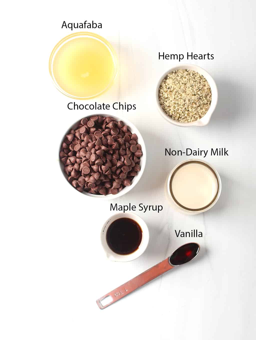 Ingredients for vegan chocolate mousse measured out and placed on a marble countertop. 
