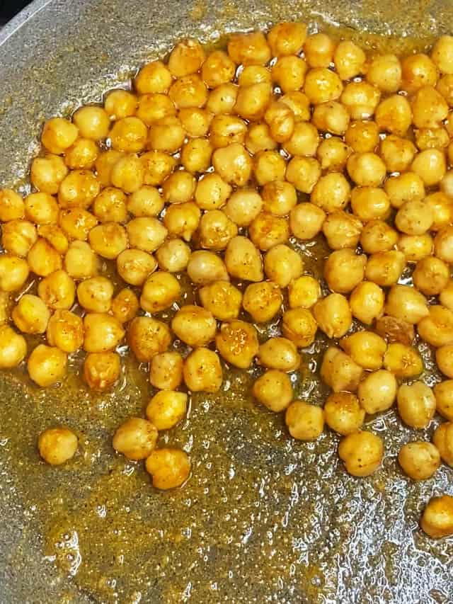 Cooking chickpeas to a crisp in oil and a gray pan