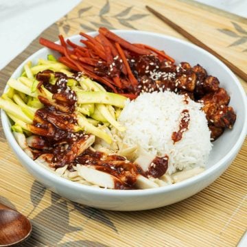 side view of yummy Vegan bibimbap bowl with marinated tofu over rice