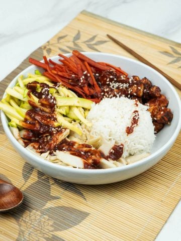 side view of yummy Vegan bibimbap bowl with marinated tofu over rice