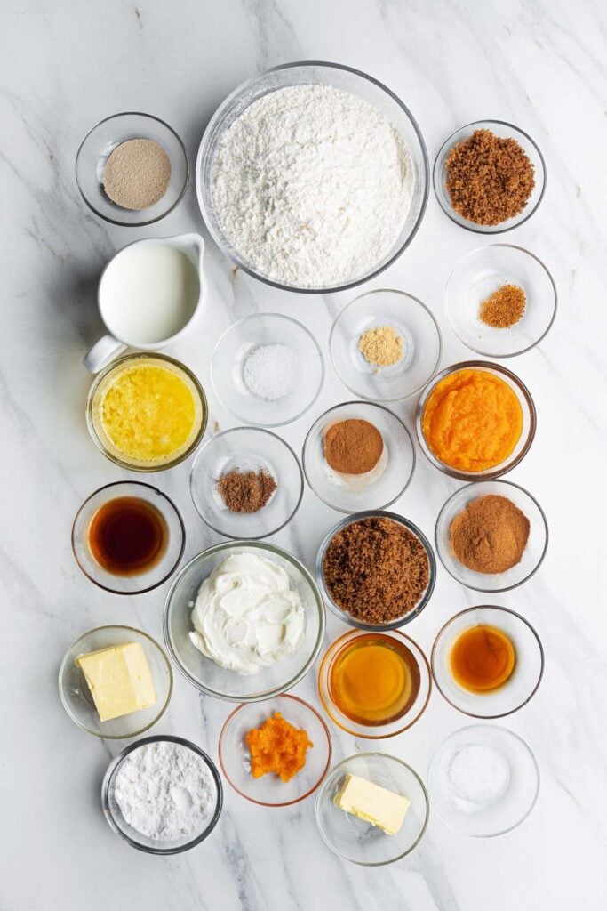 all ingredients for vegan cinnamon rolls arranged on a marble counter before baking