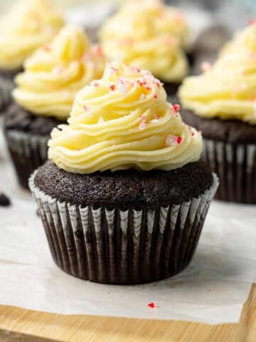 Vegan chocolate peppermint cupcakes with swirled frosting and crushed candy cane topping