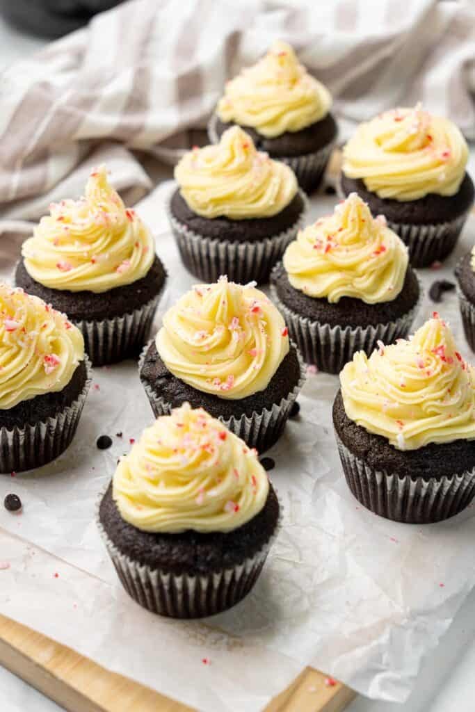 group of vegan chocolate peppermint cupcakes with dairy-free frosting and candy cane sprinkles