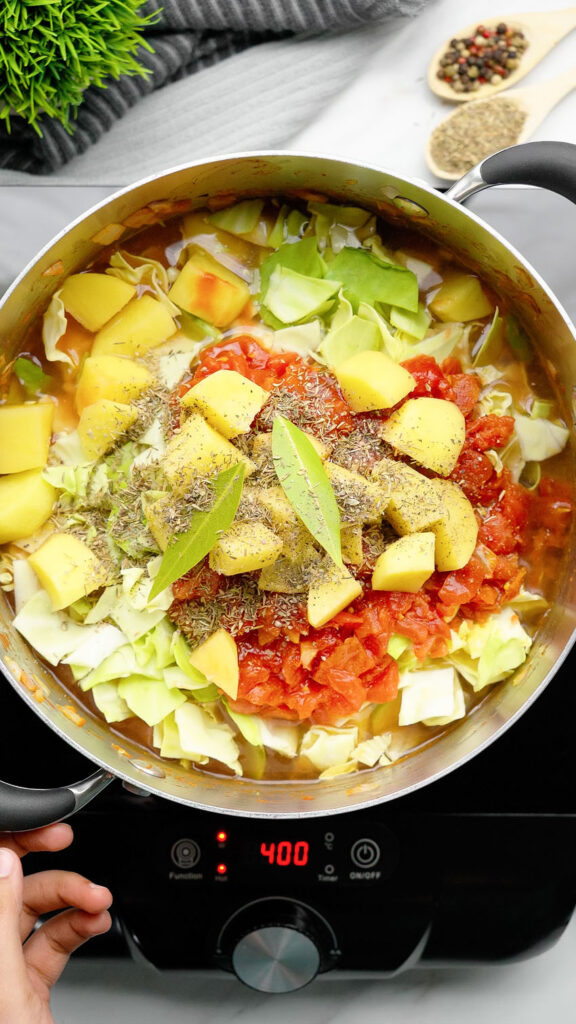 loading in all the flavorful vegetables and herbs for vegan cabbage soup