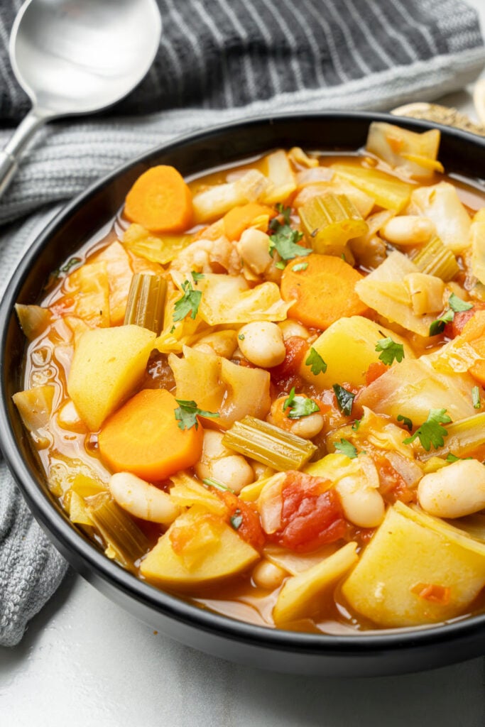 slight angle view of plant-based cabbage soup with beans and vegetables