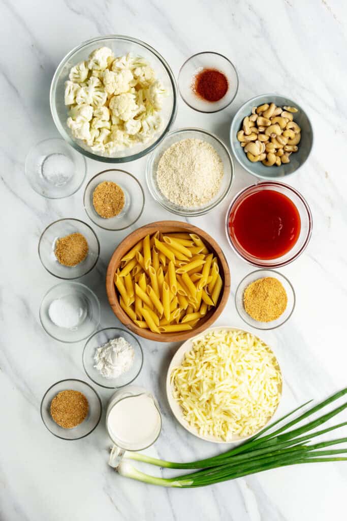 all vegan ingredients for buffalo cauliflower pasta bake including dairy-free cheese and cream