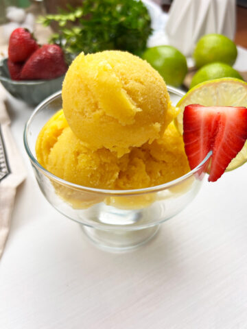close-up of smooth and creamy vegan mango ice cream in a chilled bowl
