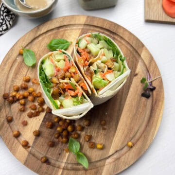 Roasted smashed chickpea wraps filled with crisp lettuce, cucumbers, carrots and tahini dressing