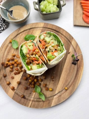 Roasted smashed chickpea wraps filled with crisp lettuce, cucumbers, carrots and tahini dressing