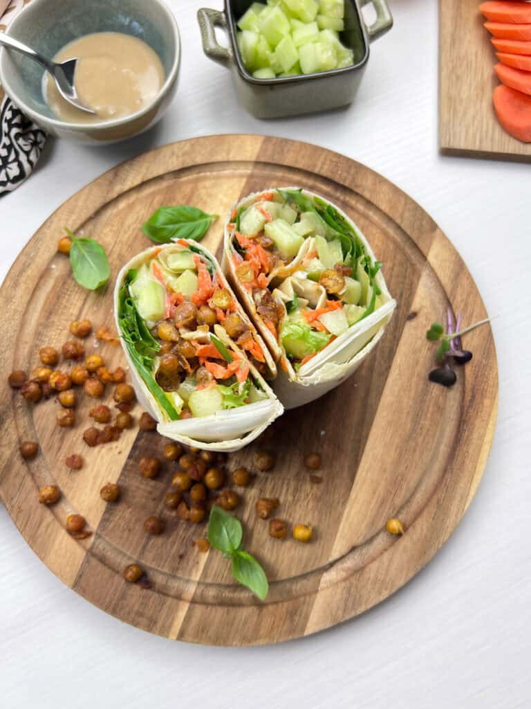Roasted smashed chickpea wraps filled with crisp lettuce, cucumbers, carrots and tahini dressing