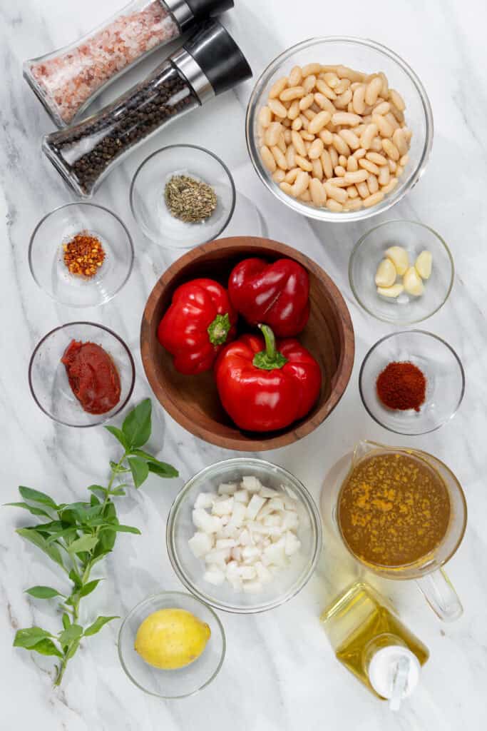 ingredients for creamy roasted red pepper soup including cannellini beans, veggies and seasonings