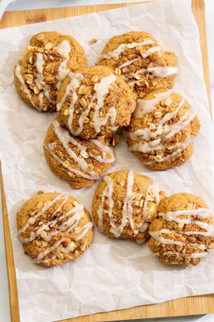handful of vegan apple cookies with a buttery oat topping and yummy vanilla glaze