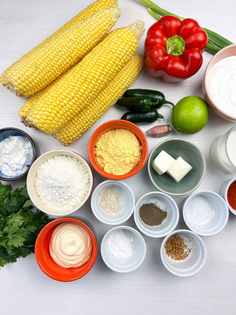 vegan corn fritter ingredients including peppers, lime, cilantro and spices