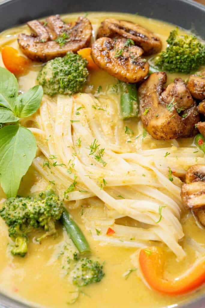 creamy mango curry noodle soup with sauteed mushrooms and mixed veggies