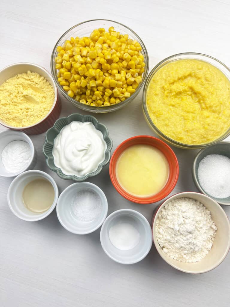 ingredients for homemade vegan casserole arranged in bowls including creamed and whole kernel corn