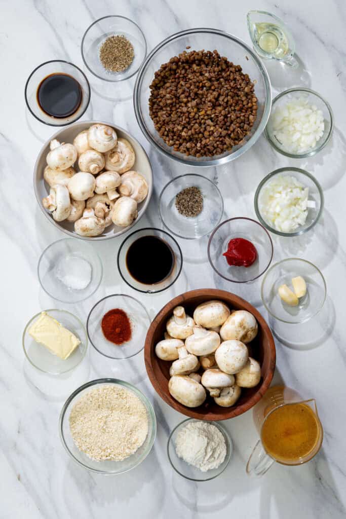 ingredients for Salisbury steak with mushroom gravy including aromatics, lentils, and broth