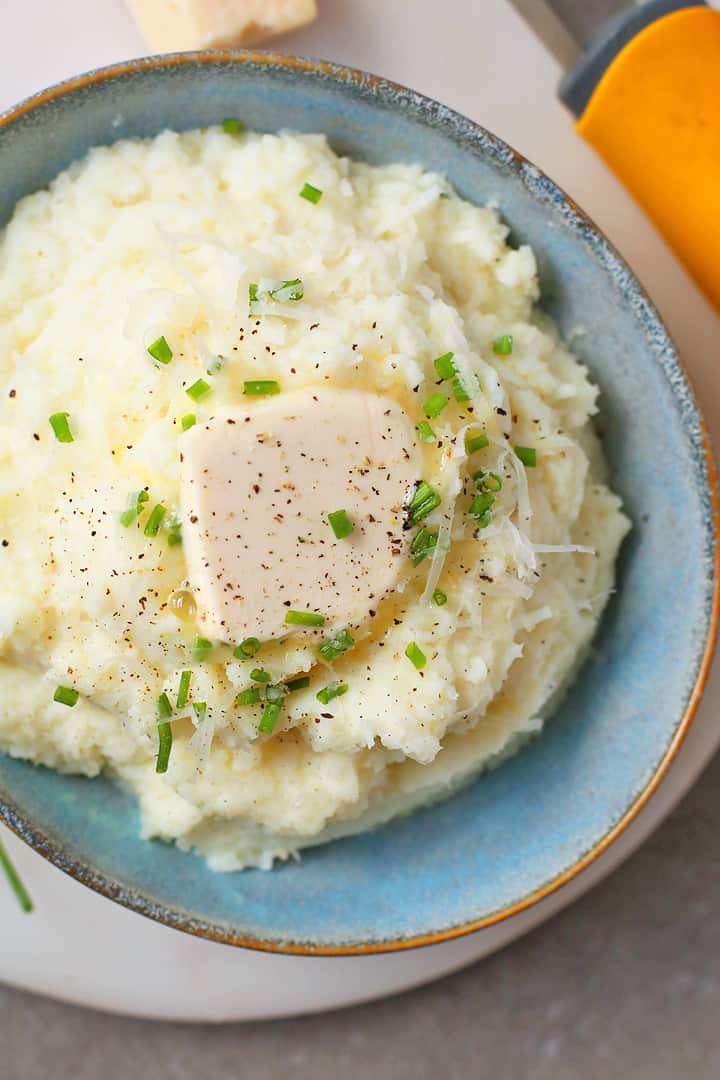 Close up of Cauliflower Mashed Potatoes with chives and butter.