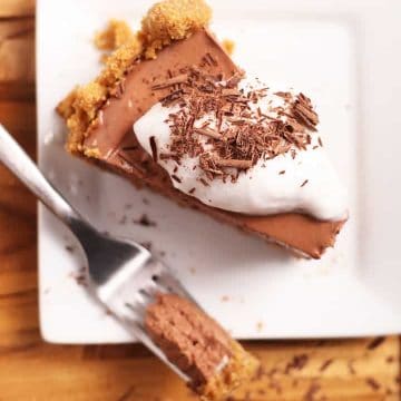 Slice of vegan chocolate pie with coconut whipped cream