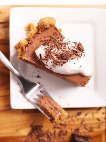 Slice of vegan chocolate pie with coconut whipped cream