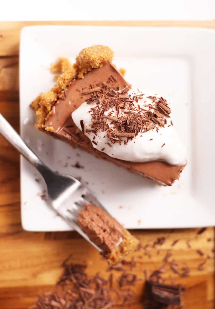 Slice of vegan chocolate pie with coconut whipped cream