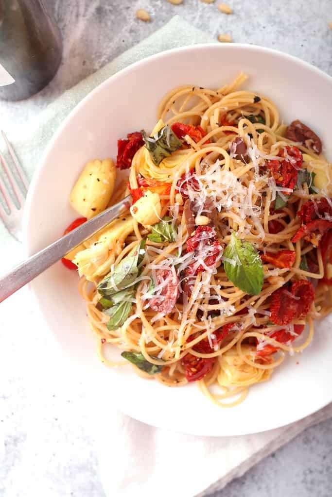 Finished pasta dish in a shallow white bowl