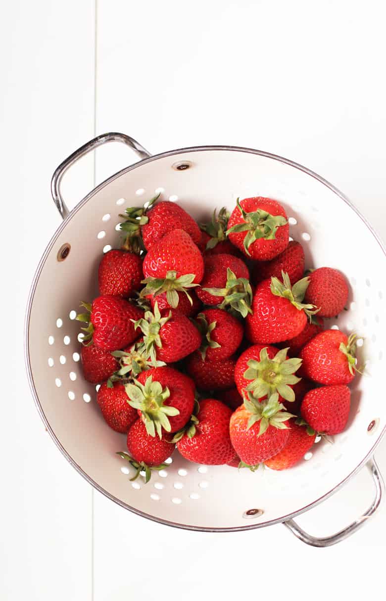 Fresh strawberries in a colander