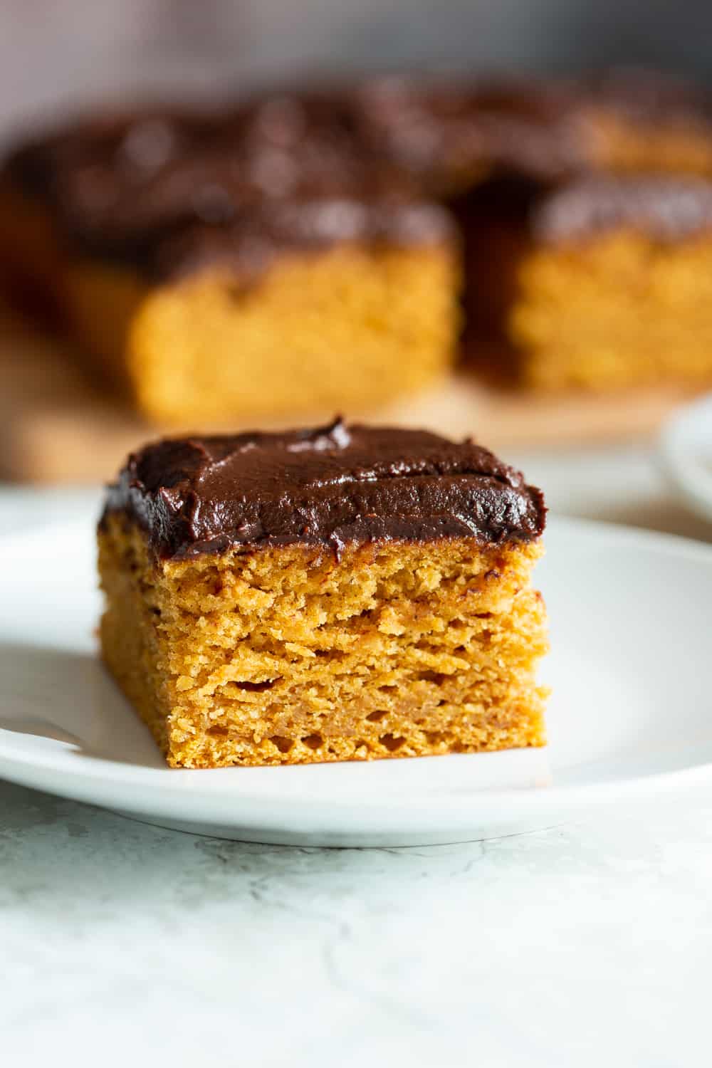 Slice of pumpkin cake on a white plate