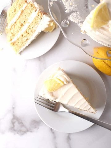 Two slices of lemon cake on white plates