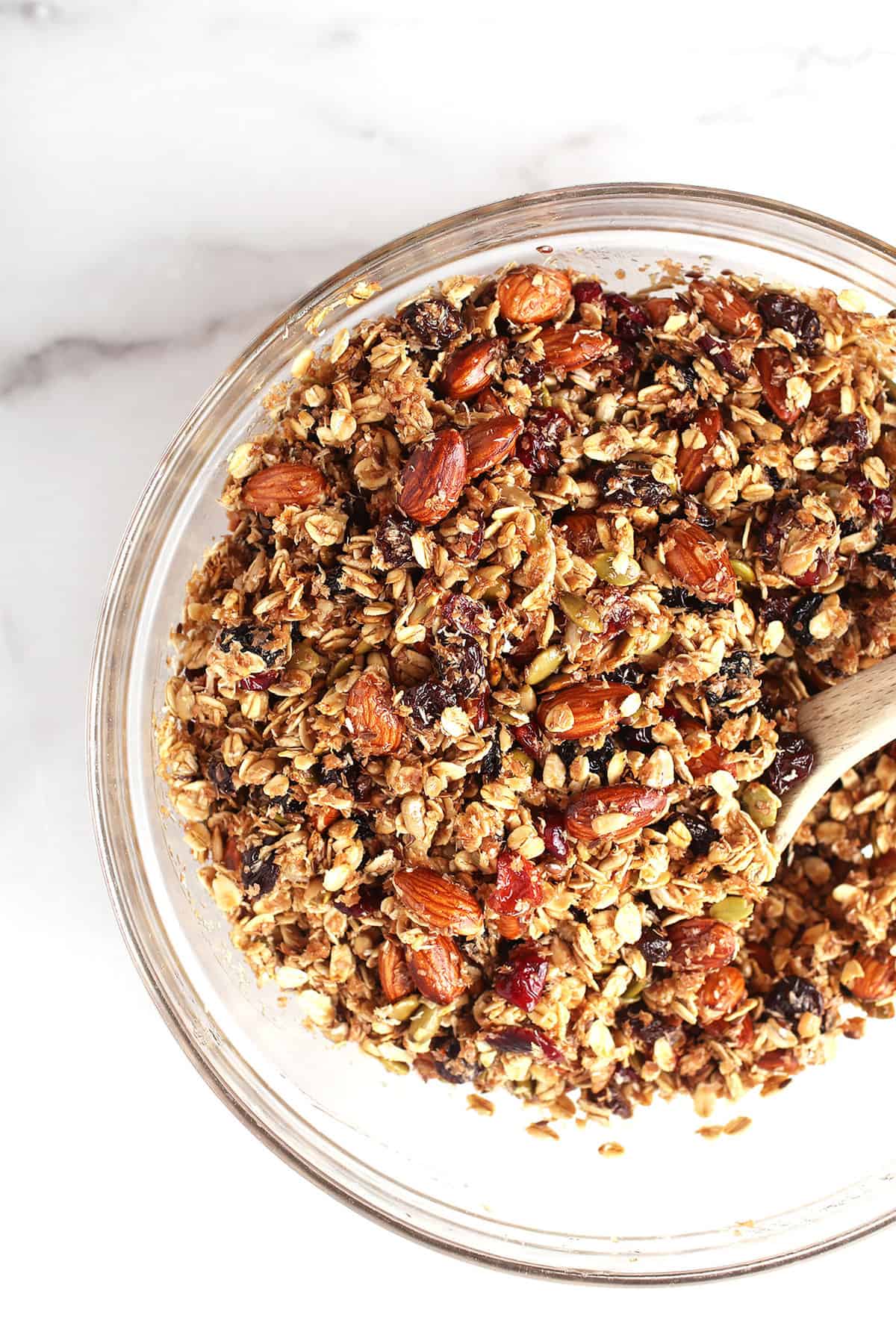 Vegan granola in a clear mixing bowl