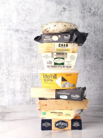 Stack of different store bought vegan cheeses